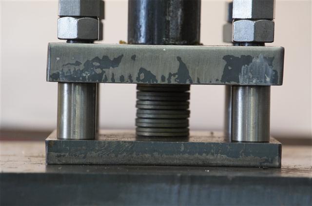 belleville washer stack at the bottom of the cycle stroke